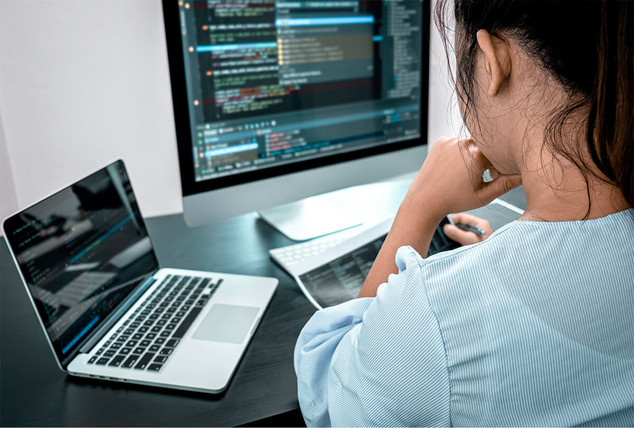 Über die Schulter eines Schülers Blick auf einen Bildschirm mit Code