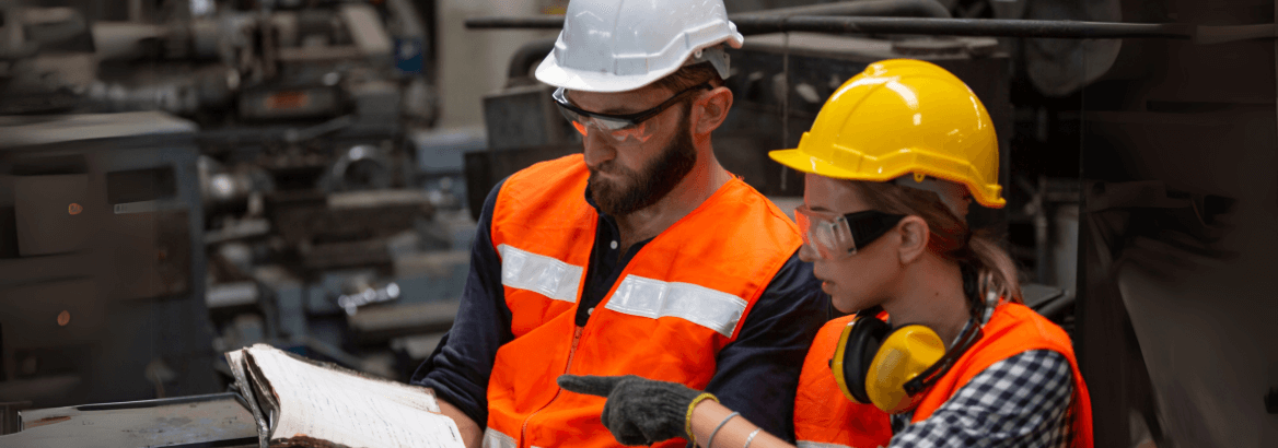 Aufnahme zweier Mitarbeiter mit einer Betriebsanleitung