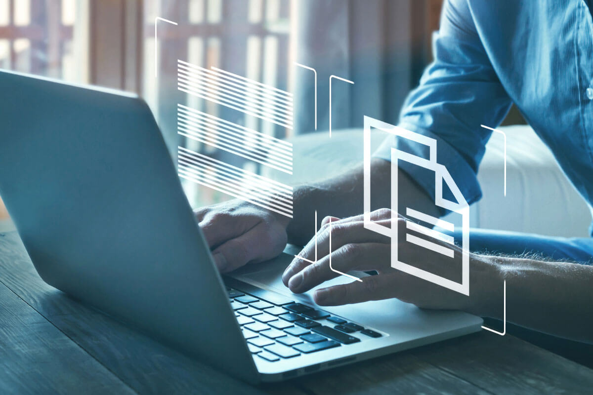 Photo detail of a man typing something on a laptop.
